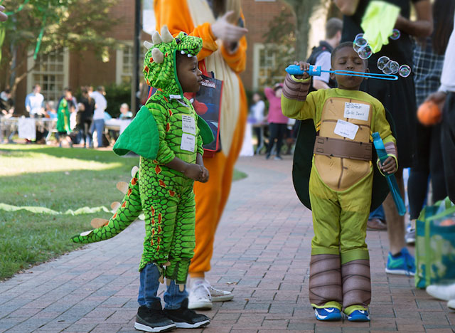 Wake Forest students host local elementary school students on campus for Project Pumpkin, a Halloween celebration.
