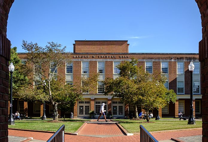 Students walk across Tribble Courtyard in front of Tribble Hall.