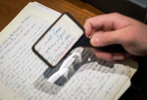 Wake Forest English professor Sharon Raynor and students in her writing class, When Writing Goes to War, look over letters and journals from soldiers in the Special Collections room of the Z. Smith Reynolds Library.