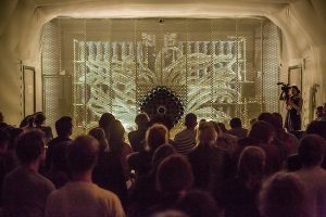 An audience stands in front of the Smeller 2.0 organ that emits smells in Osmodrama, a composition of smells.