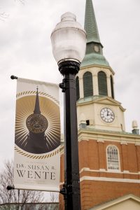 A banner on a lightpost in front of Wait Chapel reads "The Inauguration of Dr. Susan R. Wente."