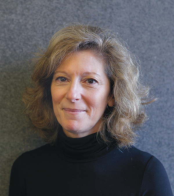 Headshot of Susan de Menil. de Menil wears a black turtleneck.