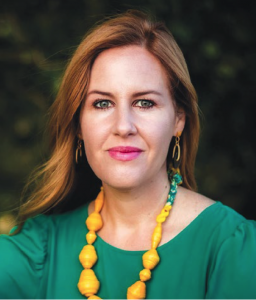 Millie Kerr wearing a green shirt with a yellow necklace