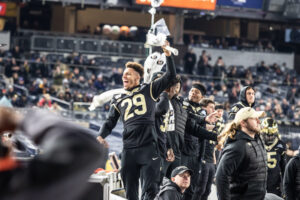 A Wake Forest football player wearing jersey number 29 jumps up in the air after a win at the New Era Pinstripe Bowl at Yankee Stadium.