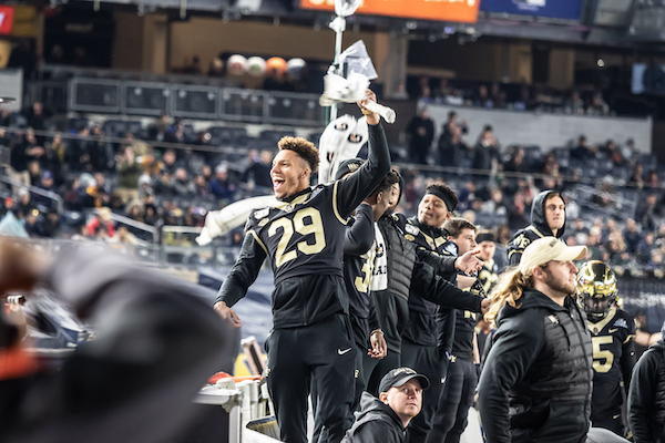 A Wake Forest football player wearing jersey number 29 jumps up in the air after a win at the New Era Pinstripe Bowl at Yankee Stadium.