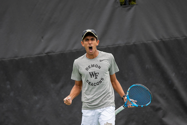 A Wake Forest tennis player shouts after a play.