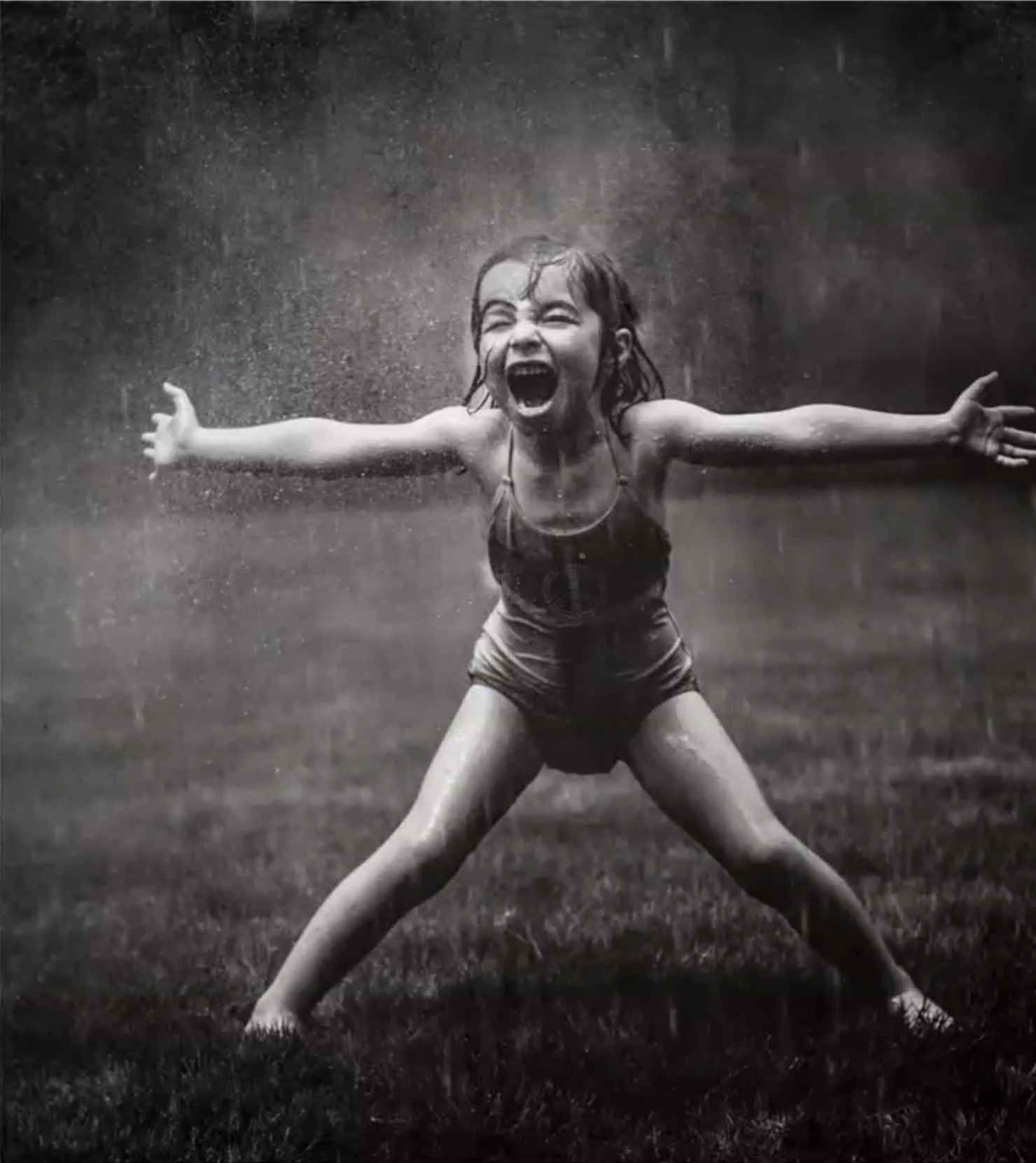 Exuberant Ella, the daughter of Kate T. Parker, enjoying a sprinkler. 