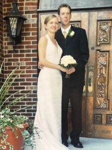 Matt Kerr in his tuxedo and Jill Snyder Kerr in a sleeveless wedding dress