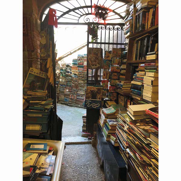 A room with stacks and stacks of books