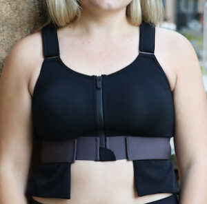 The Resilience Bra, which is black and has a zipper and wide straps