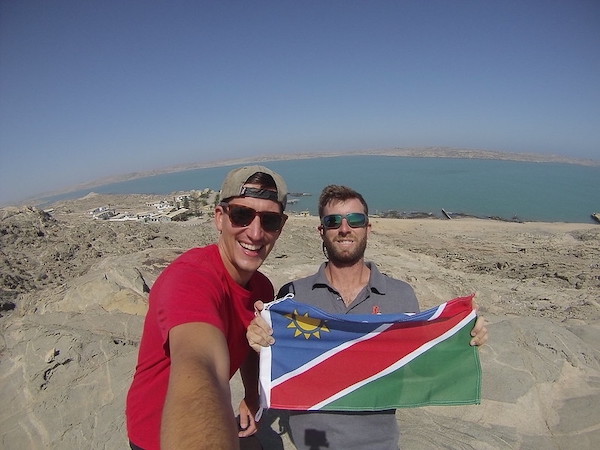 Eric Bihl and Kennon Jones taking a selfie with a flag