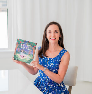 Lisa Norman holding up her "Love" book