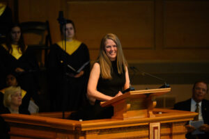 Hundreds of people attend a Memorial Service for Edwin G. Wilson at Wait Chapel on Friday, May 3, 2024. Laurie Turnage Wilson provides remarks during the memorial.