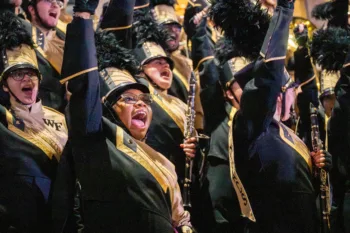 Wake Forest University alumni, students and football fans come to celebrate with the university band at a fan central event on Thursday January 1st, 2026. Marching band members can get merit-based scholarships starting this fall.