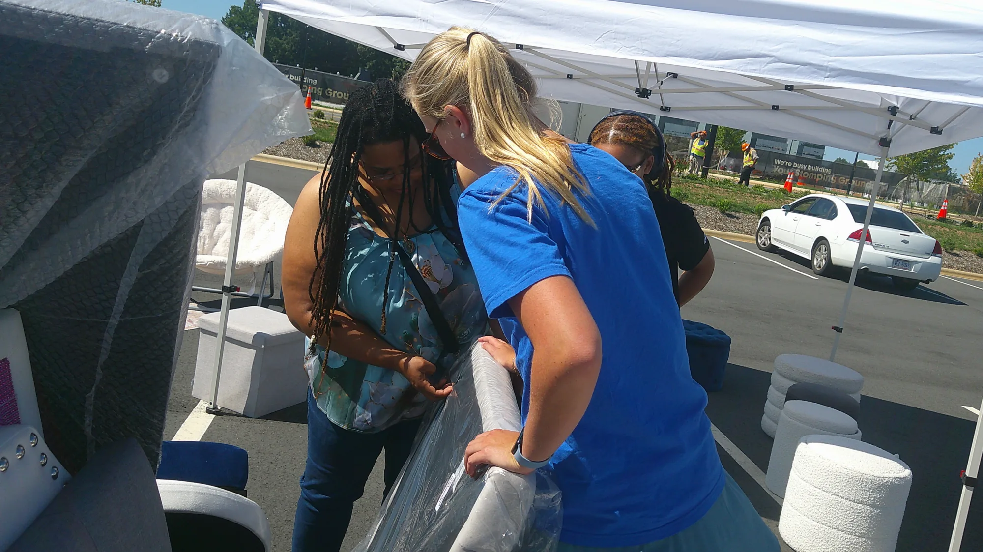 Anna Anstey (’26) looks at a headboard with one of her customers during a pop-up shop for her business, Campus Reclaimed.