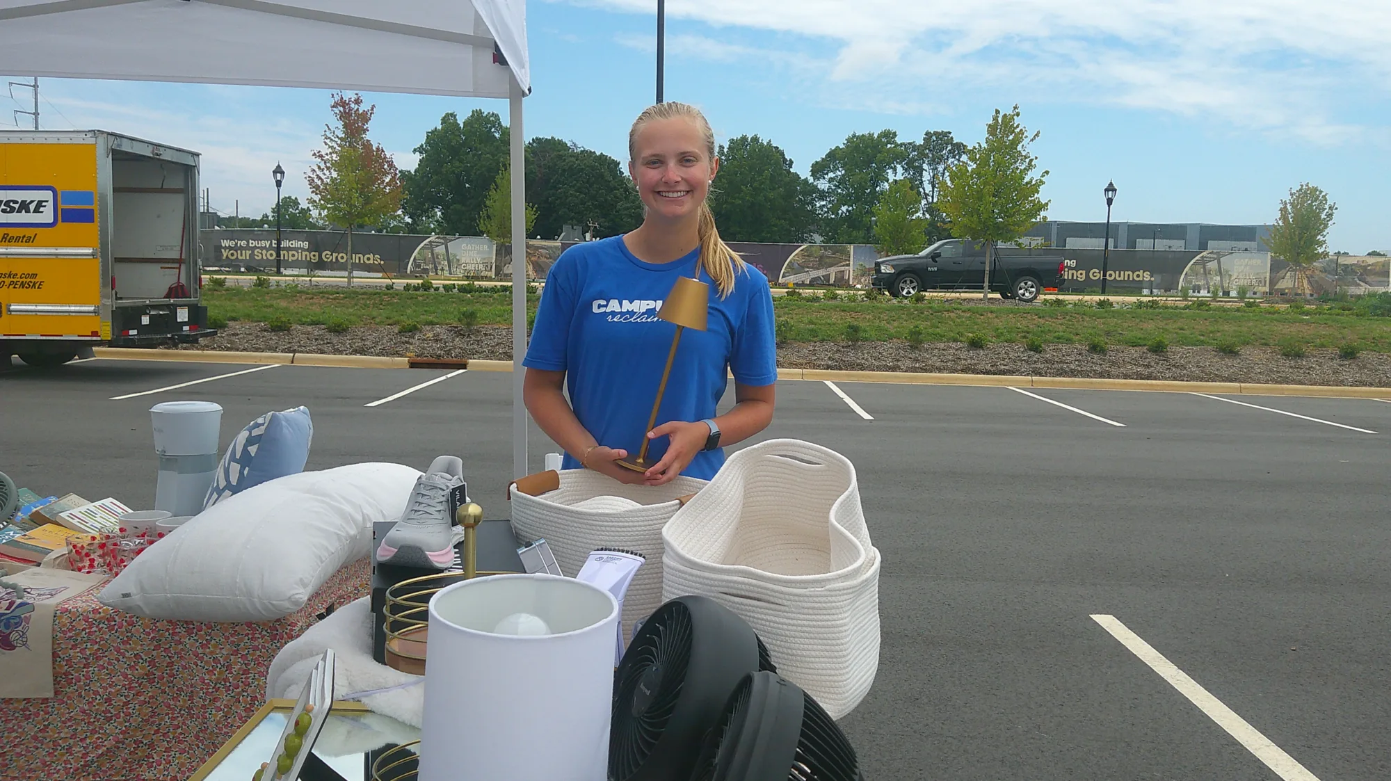 Anna Anstey (’26) holds a lamp during a pop-up shop for her business, Campus Reclaimed.