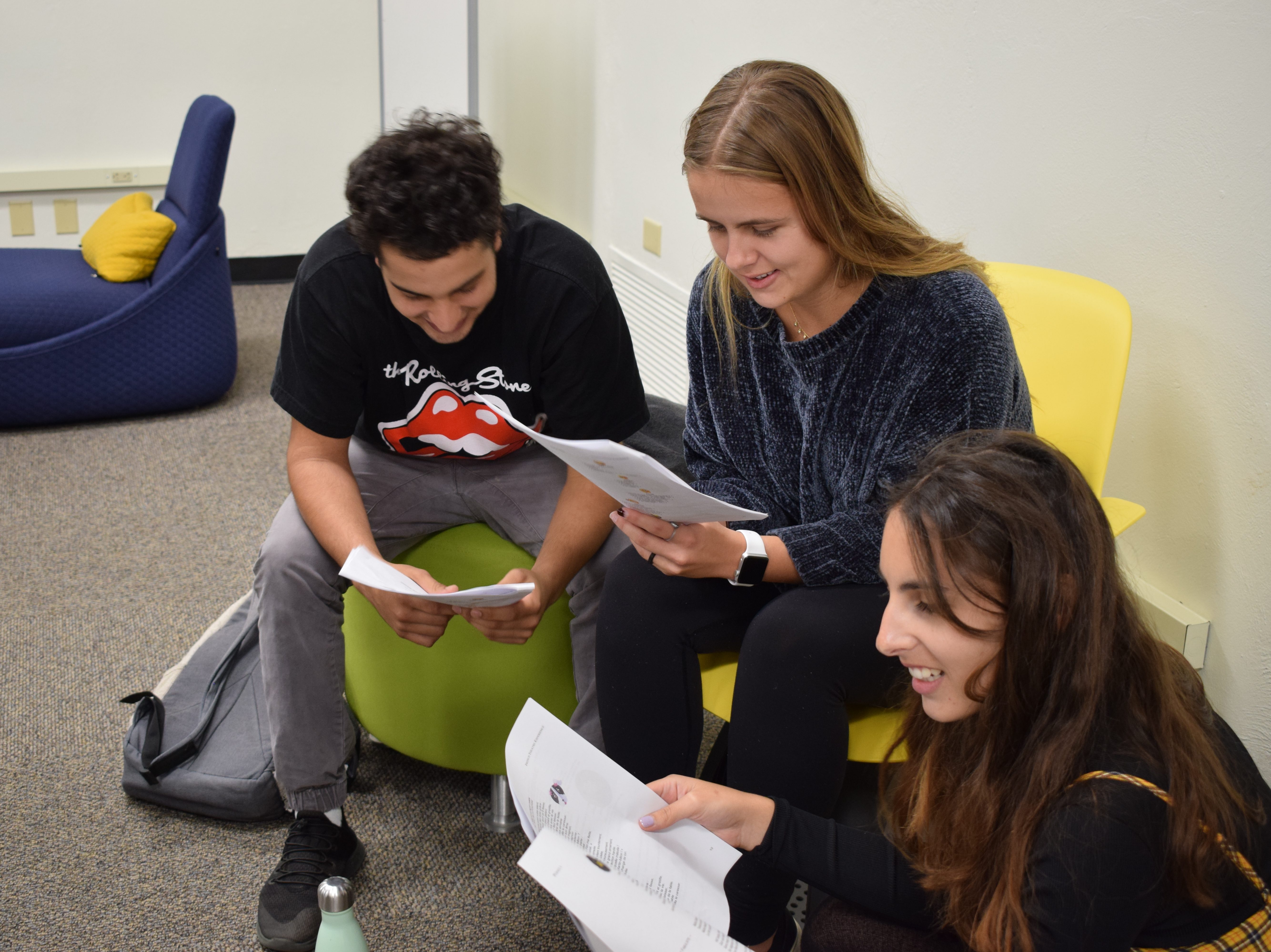 Three students working together in class