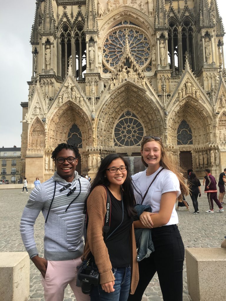 Three students standing in front of the Notre Dame Cathedral