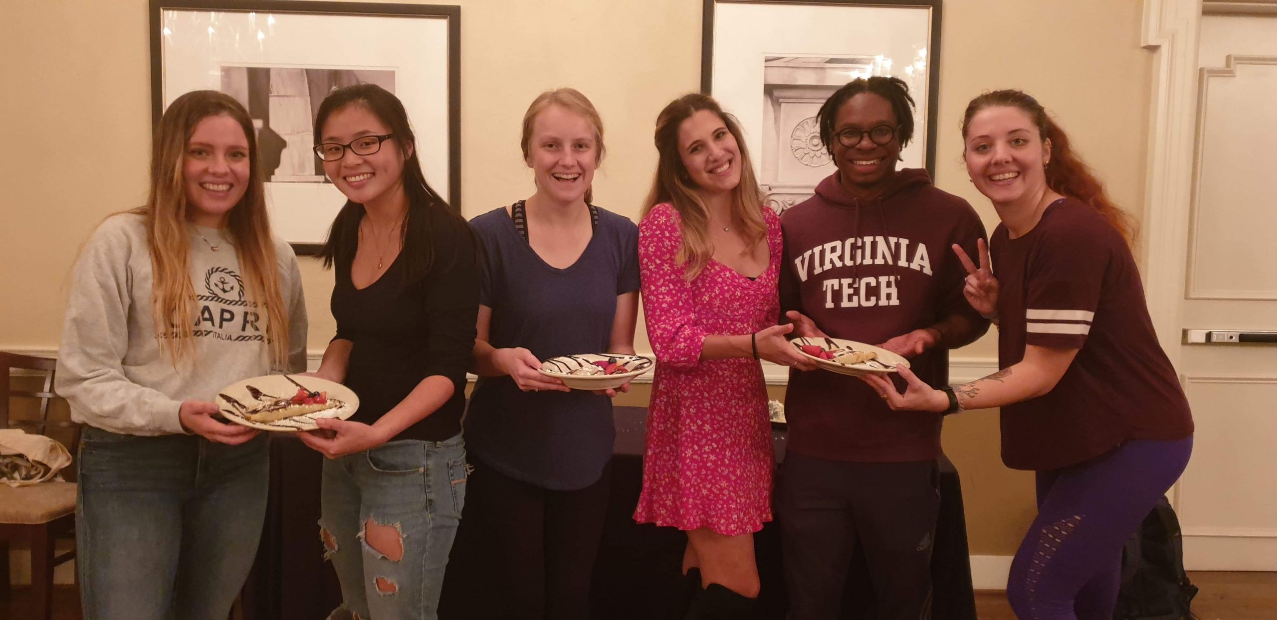 French Club students holding plates of crepes at International Desserts Day