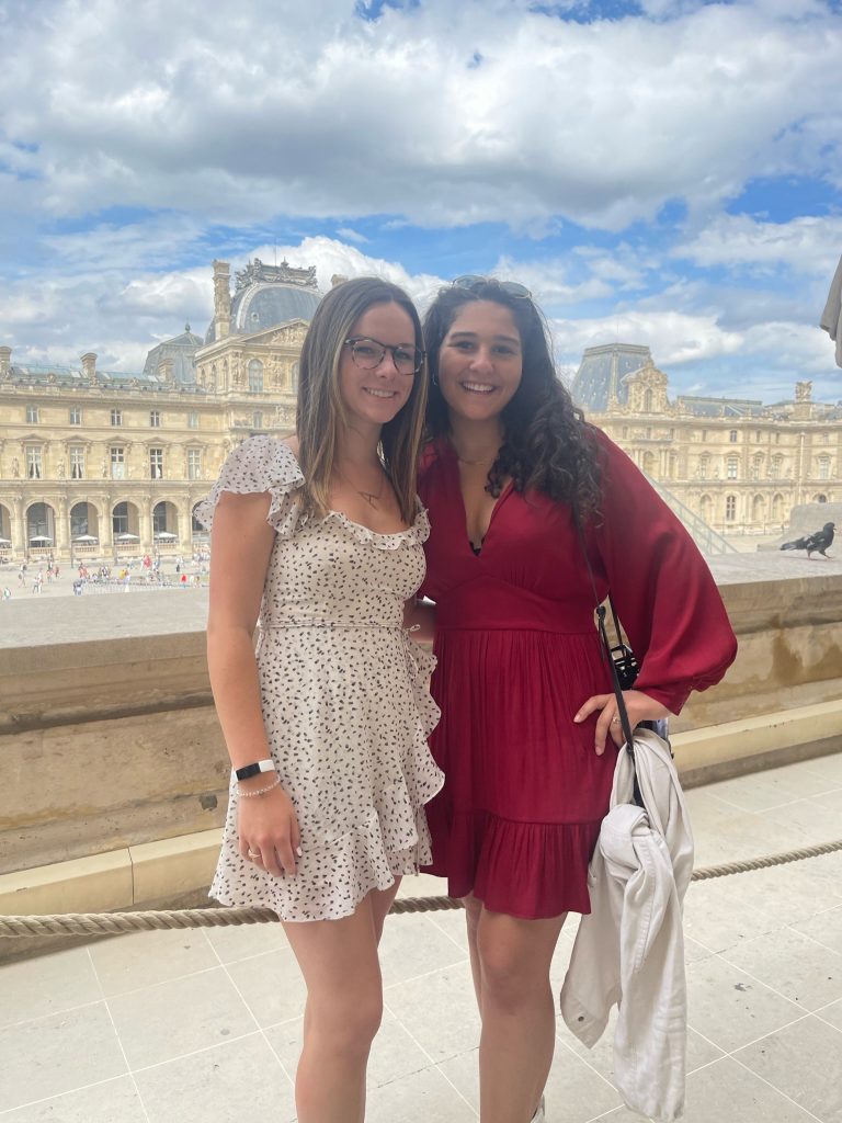 Two students standing in front of a mansion in Tours