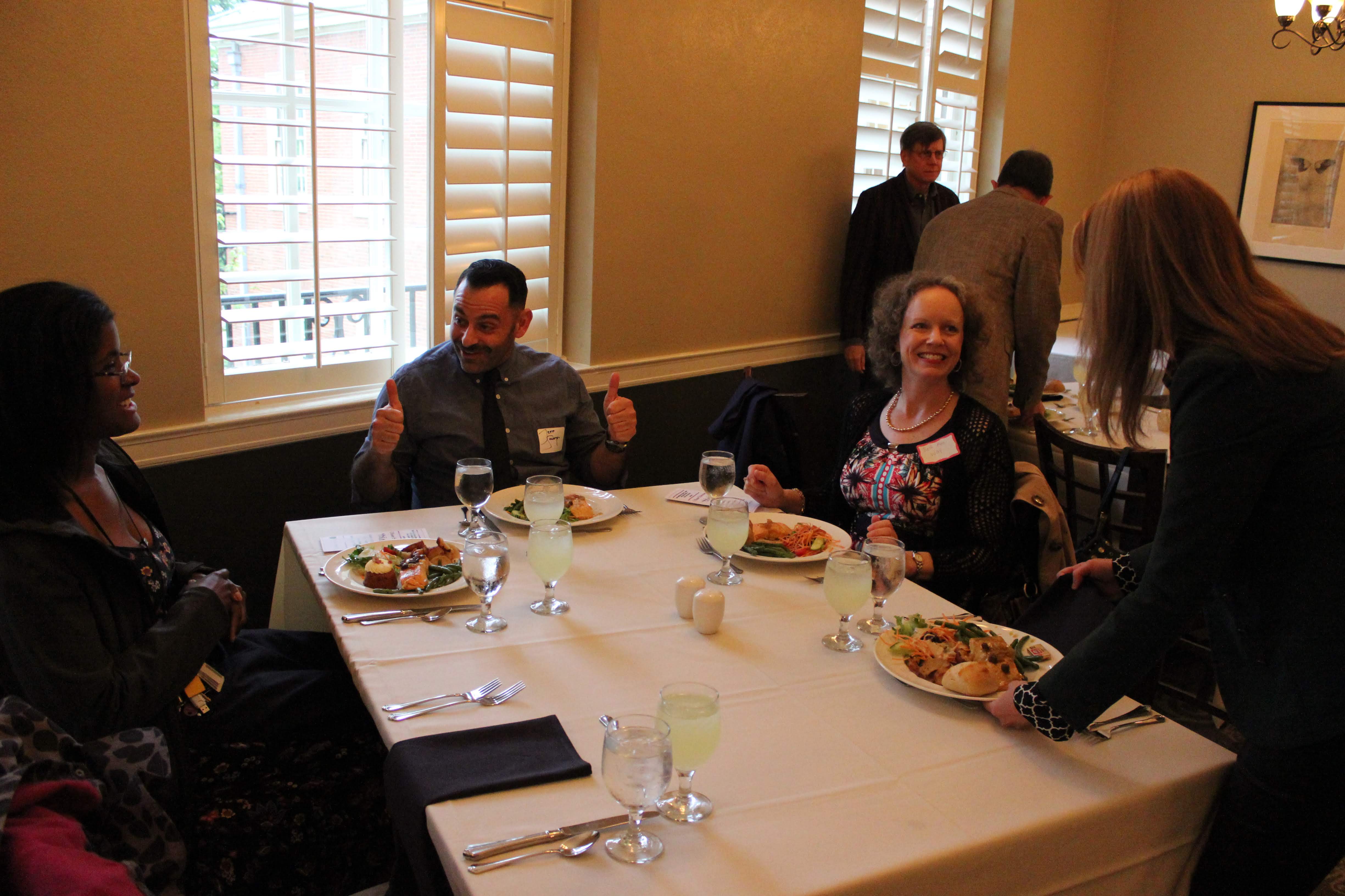 WGSS faculty sitting together at dining table