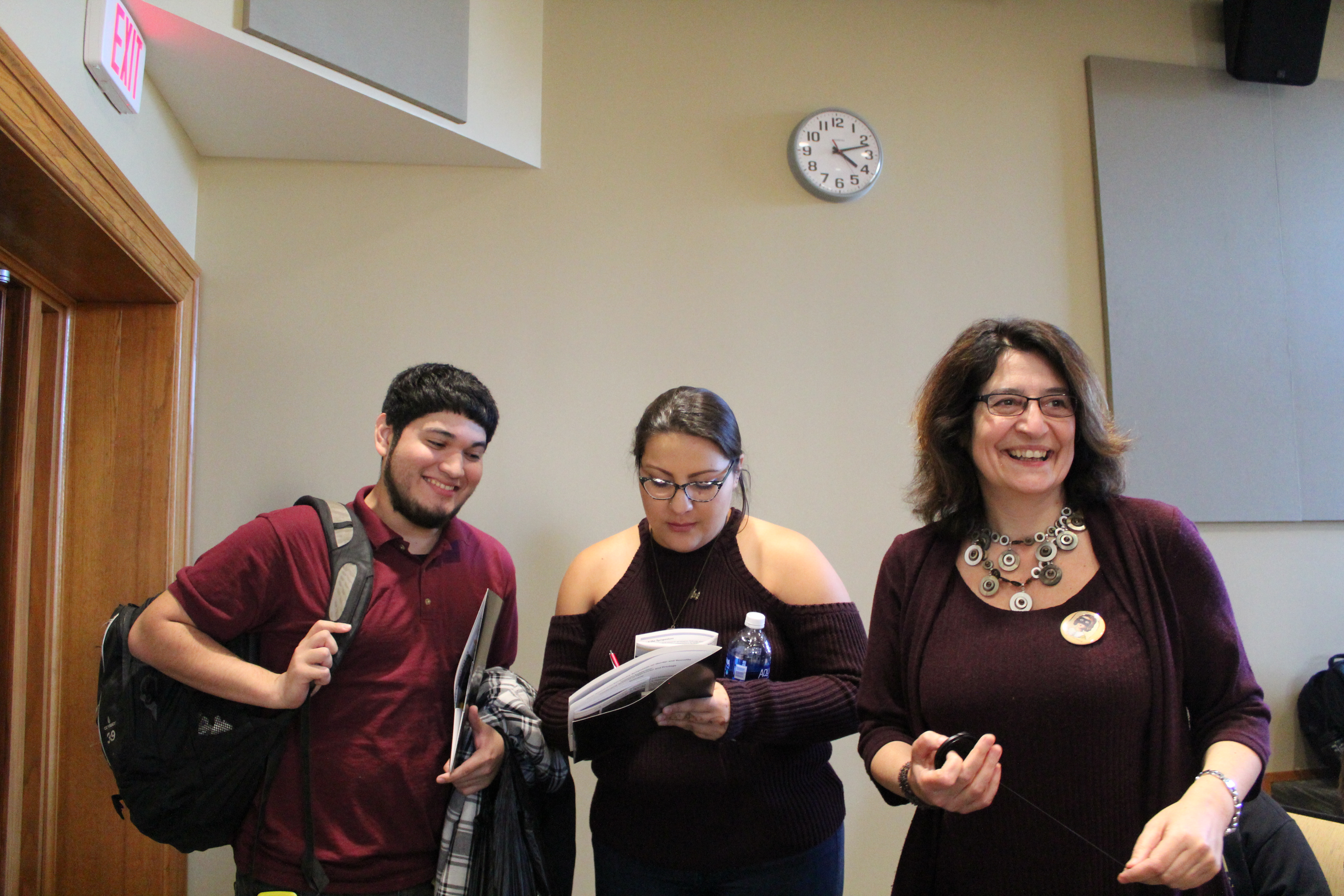 Two students and a teacher smiling