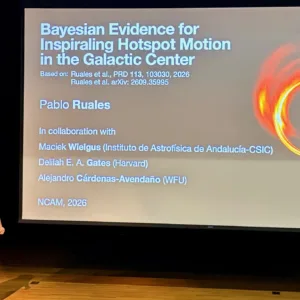Pablo Ruales stands beside a projected slide titled “Bayesian Evidence for Inspiraling Hotspot Motion in the Galactic Center” at NCAM 2026. The slide includes a bright ring around a black hole and a Wake Forest University logo.
