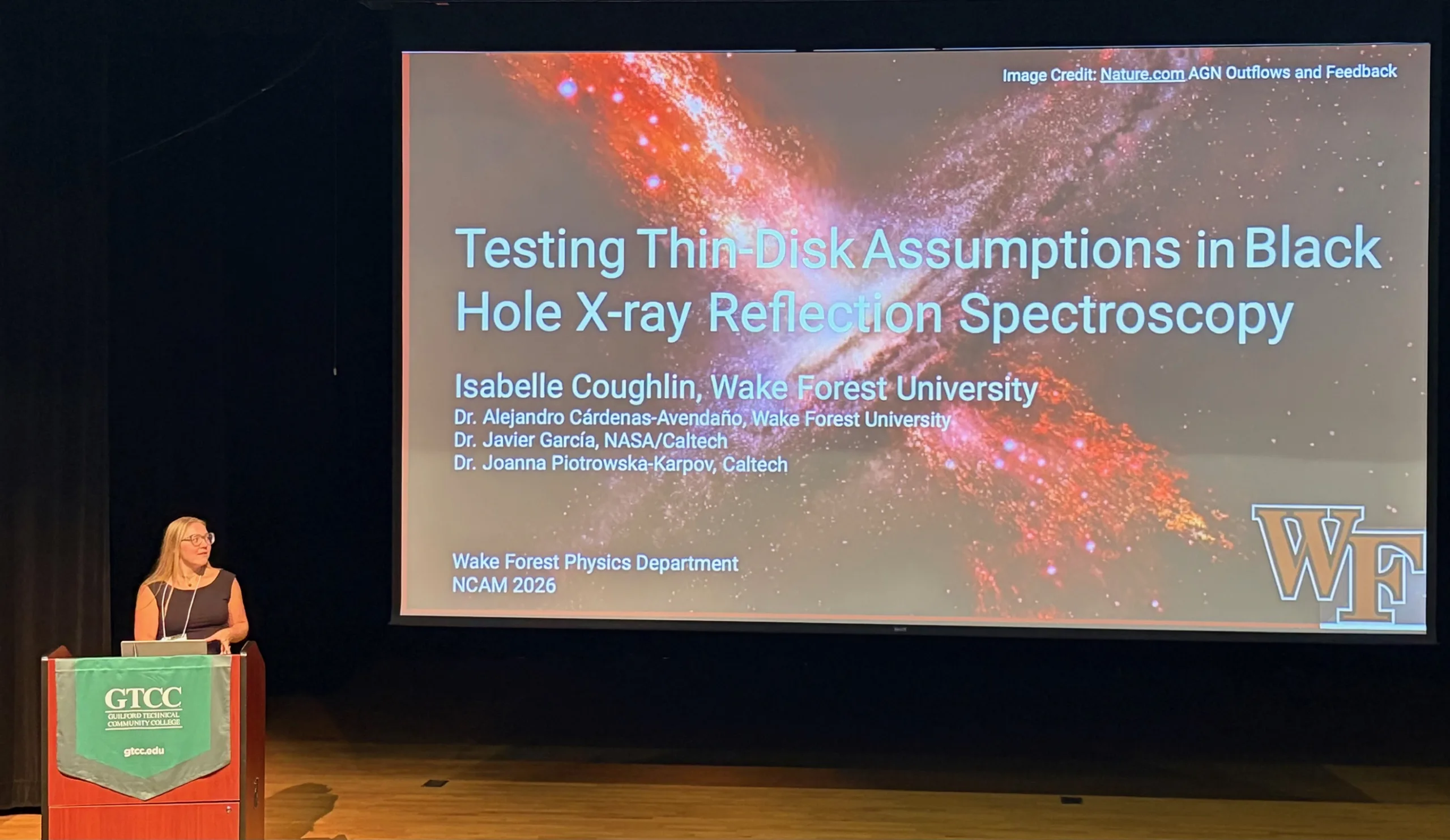 Isabelle Coughlin stands at a GTCC lectern beside a projected slide titled “Testing Thin-Disk Assumptions in Black Hole X-ray Reflection Spectroscopy” at NCAM 2026. The slide includes a galaxy image and a Wake Forest logo.