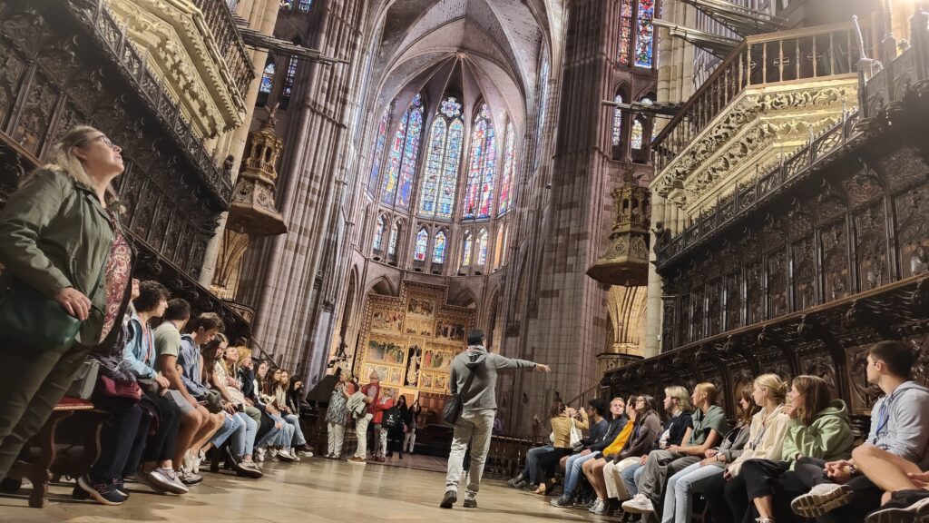 Students listen to a lecture in a Spanish cathedral.