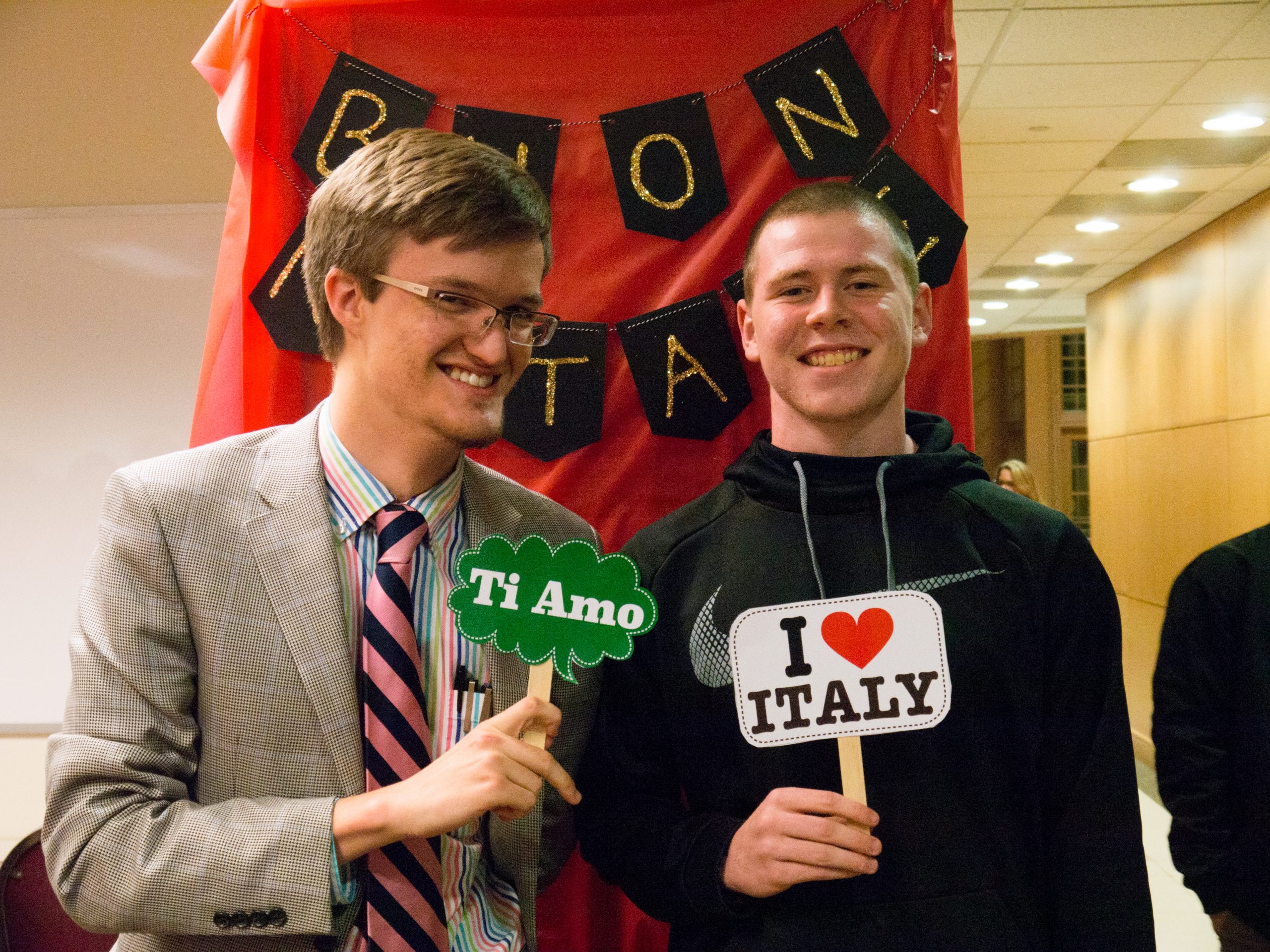 Italian club members holding signs saying "Ti Amo" and "I love Italy"