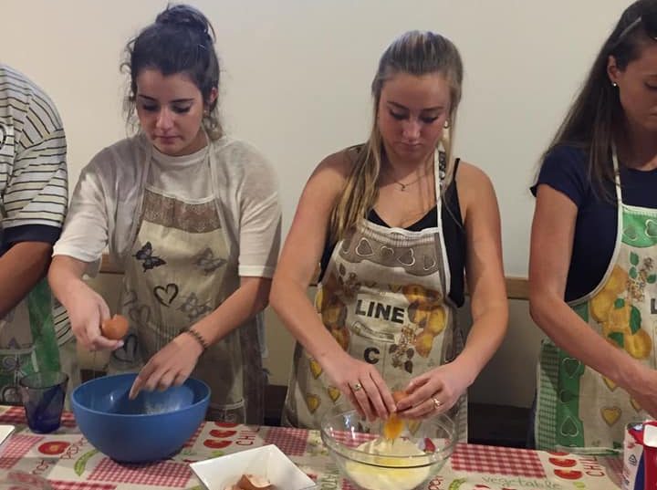 Italian club members making pizza dough together