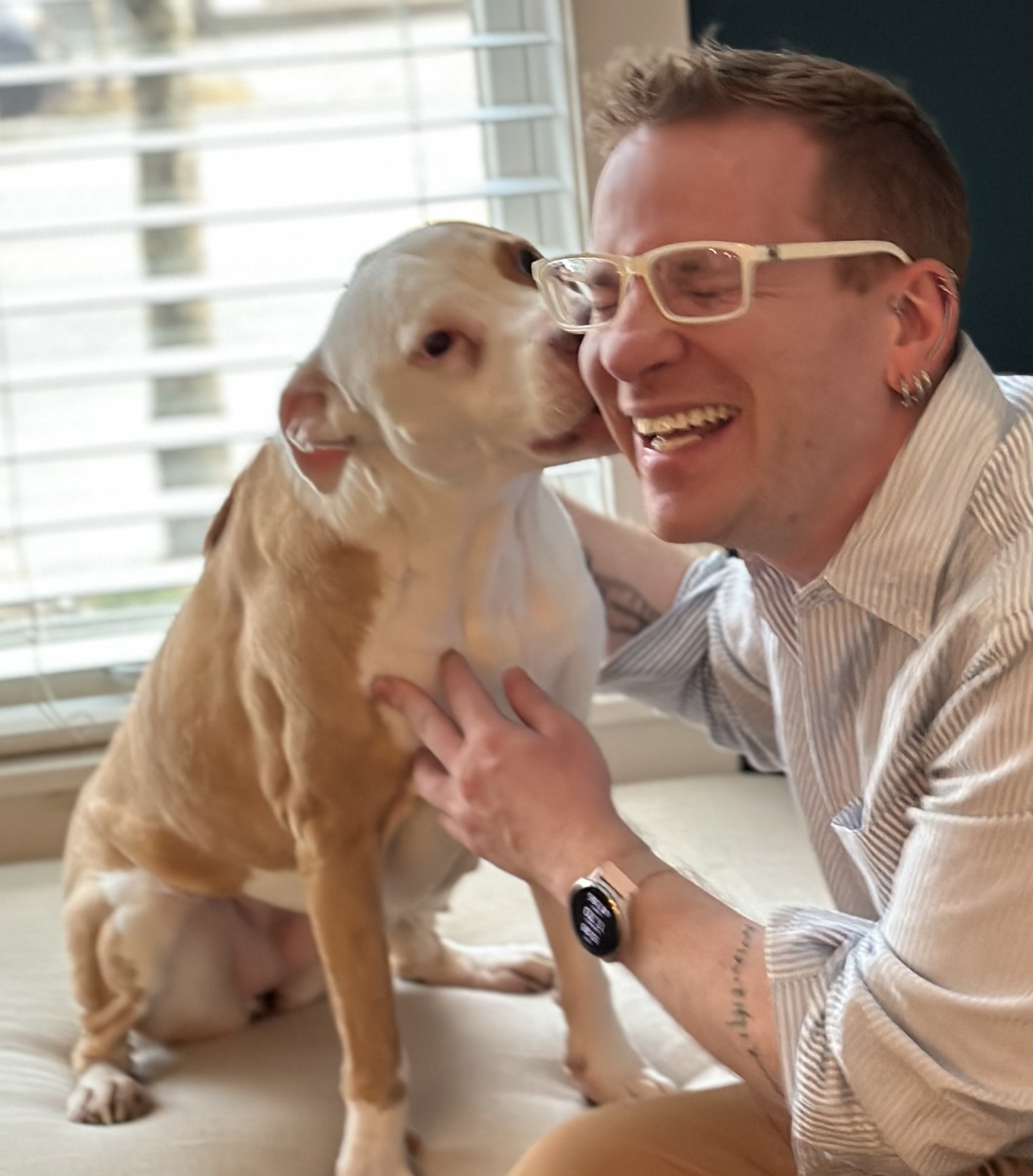 Photo of Professor T. H. M. Gellar-Goad smiling with a dog