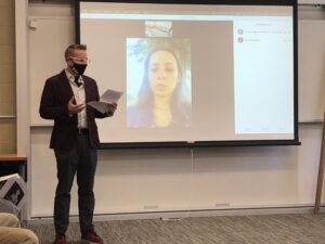 Photo from the portrait unveiling event showing Professor T. H. M. Gellar-Goad and a student joining virtually