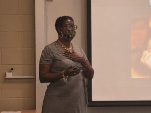 Photo from the portrait unveiling event showing the artist's wife speaking