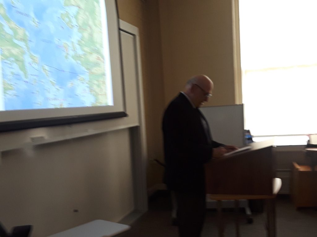 professor reading at podium