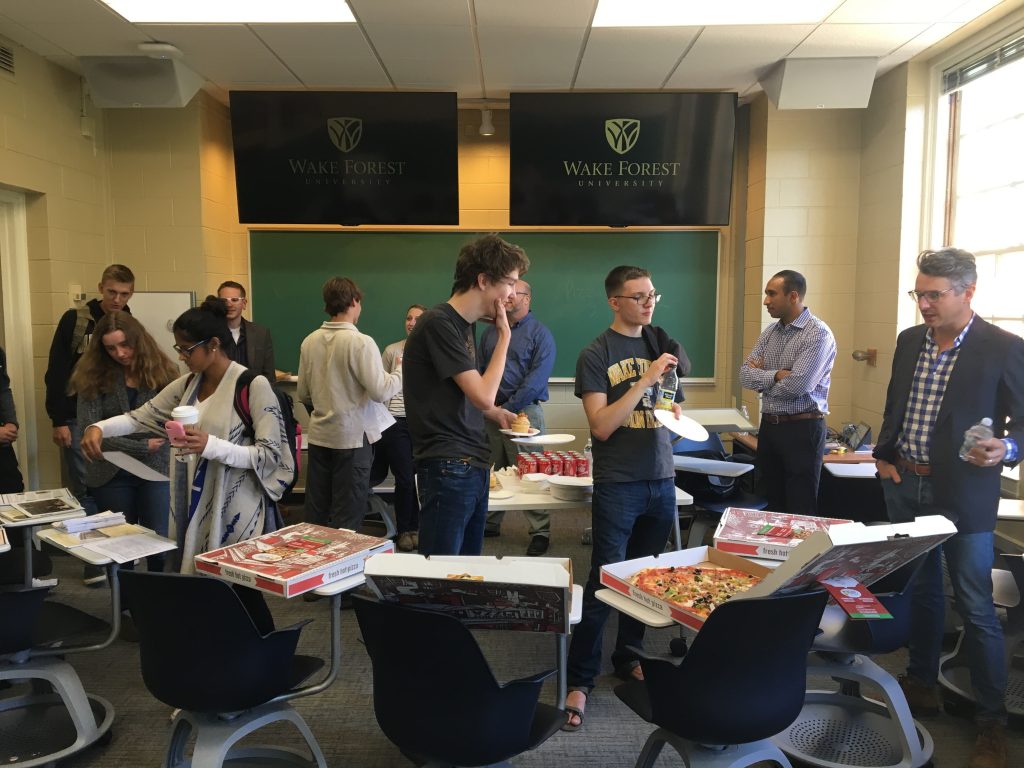 students and teachers at dept event with pizza
