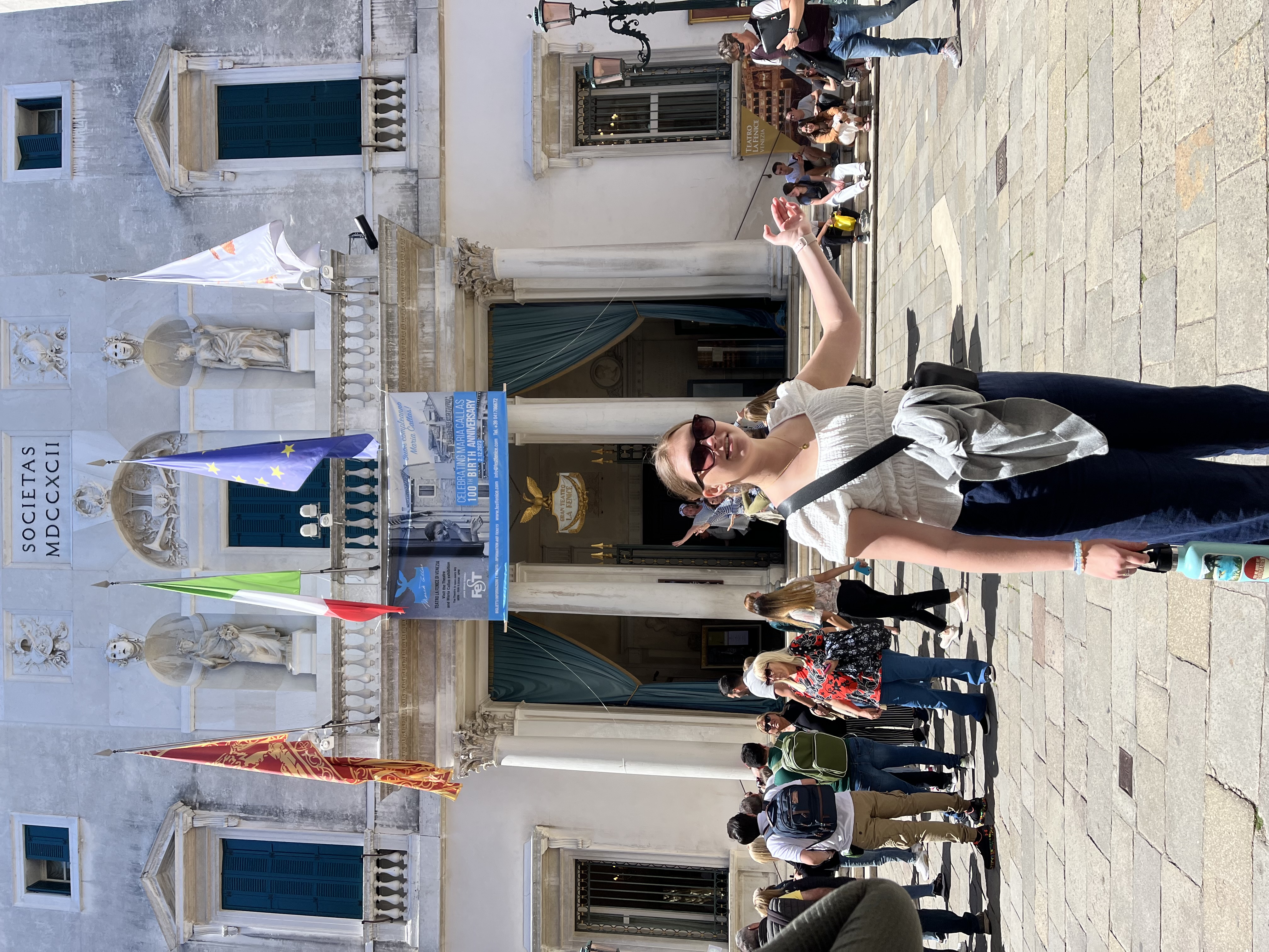 A student poses in front of Teatro La Fenice in Venice in 2023.