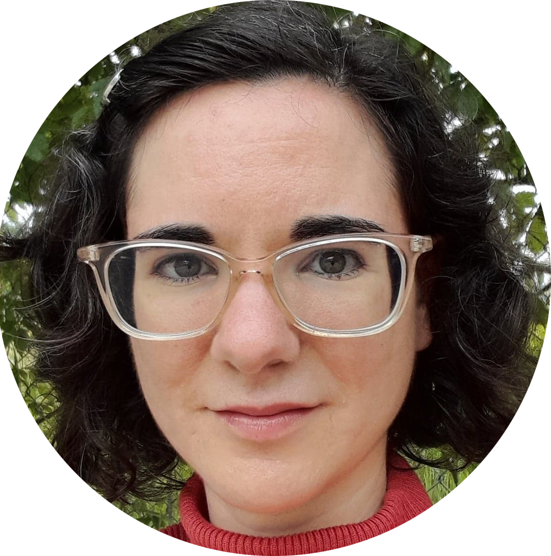 Profile picture of Rachel Mazzara: a white woman with cheek-length wavy black hair and clear-framed glasses, wearing a red turtleneck.