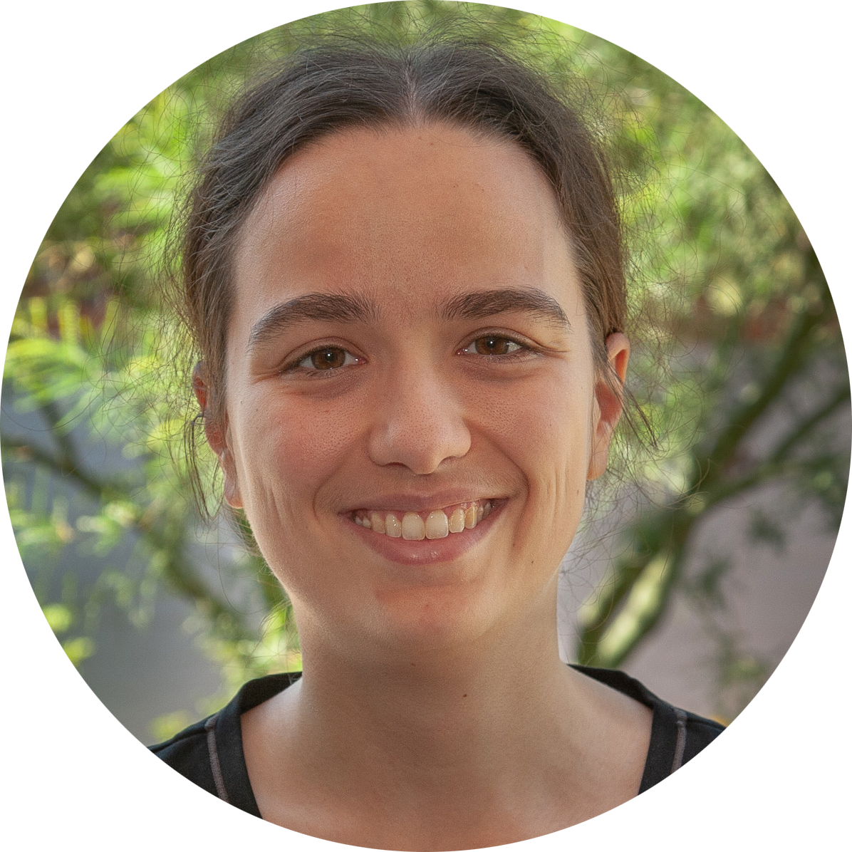 Profile picture of Emma Warhover: a white woman with wavy brown hair. She is smiling and wearing a black v-neck.