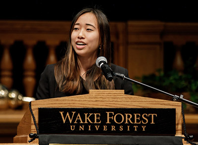 Celia Zhou speaks at the lectern