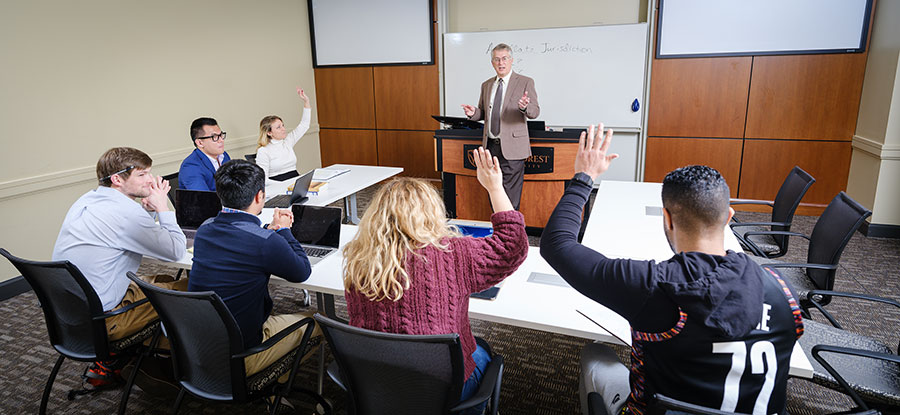 Professor teaching to a small group of students.