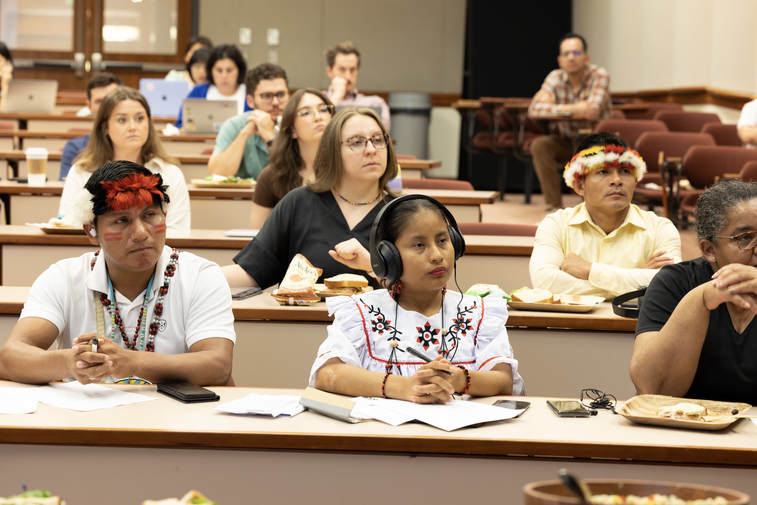 Young Indigenous Leaders from Peruvian Amazon sitting in the audience. 