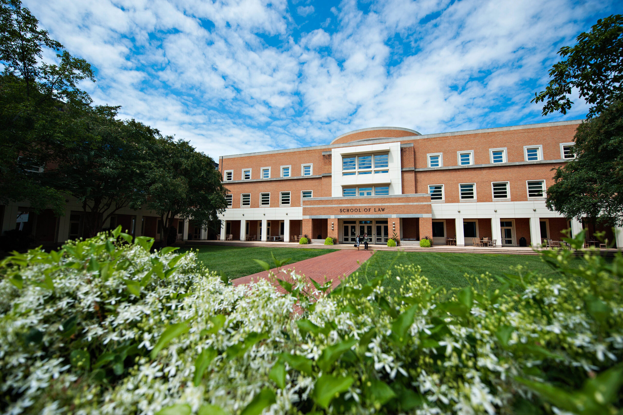 Worrell Professional Center Building, home to Wake Forest Law, with a bright blue partly cloudy sky in the background.