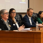 Professor Tanya Marsh talking on a panel with three others during the Future of Death Care in America symposium