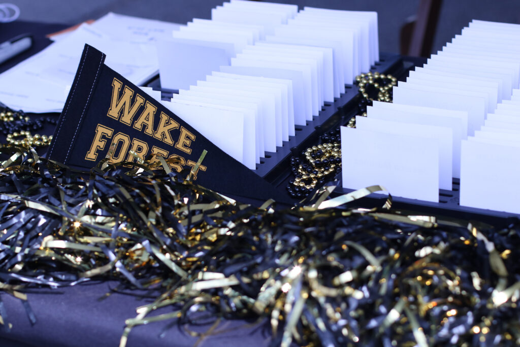 Black and gold ribbons in front of a small Wake Forest pennant.