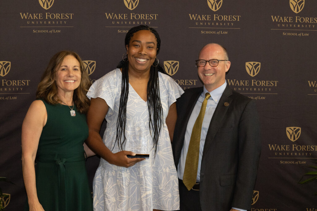 Dean Klein posing for a picture with two women at a Wake Forest Law event.