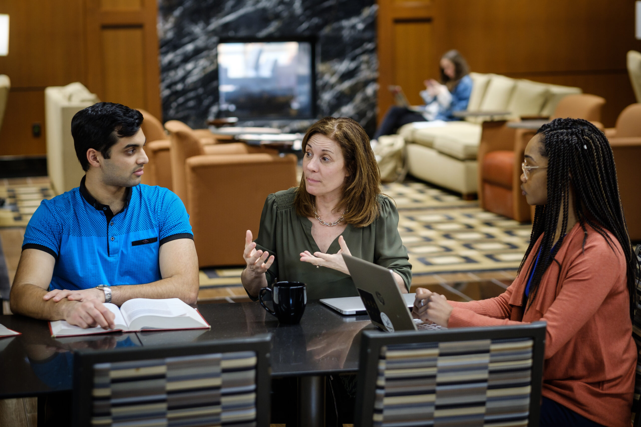 A Wake Forest Law professor talking to two students.