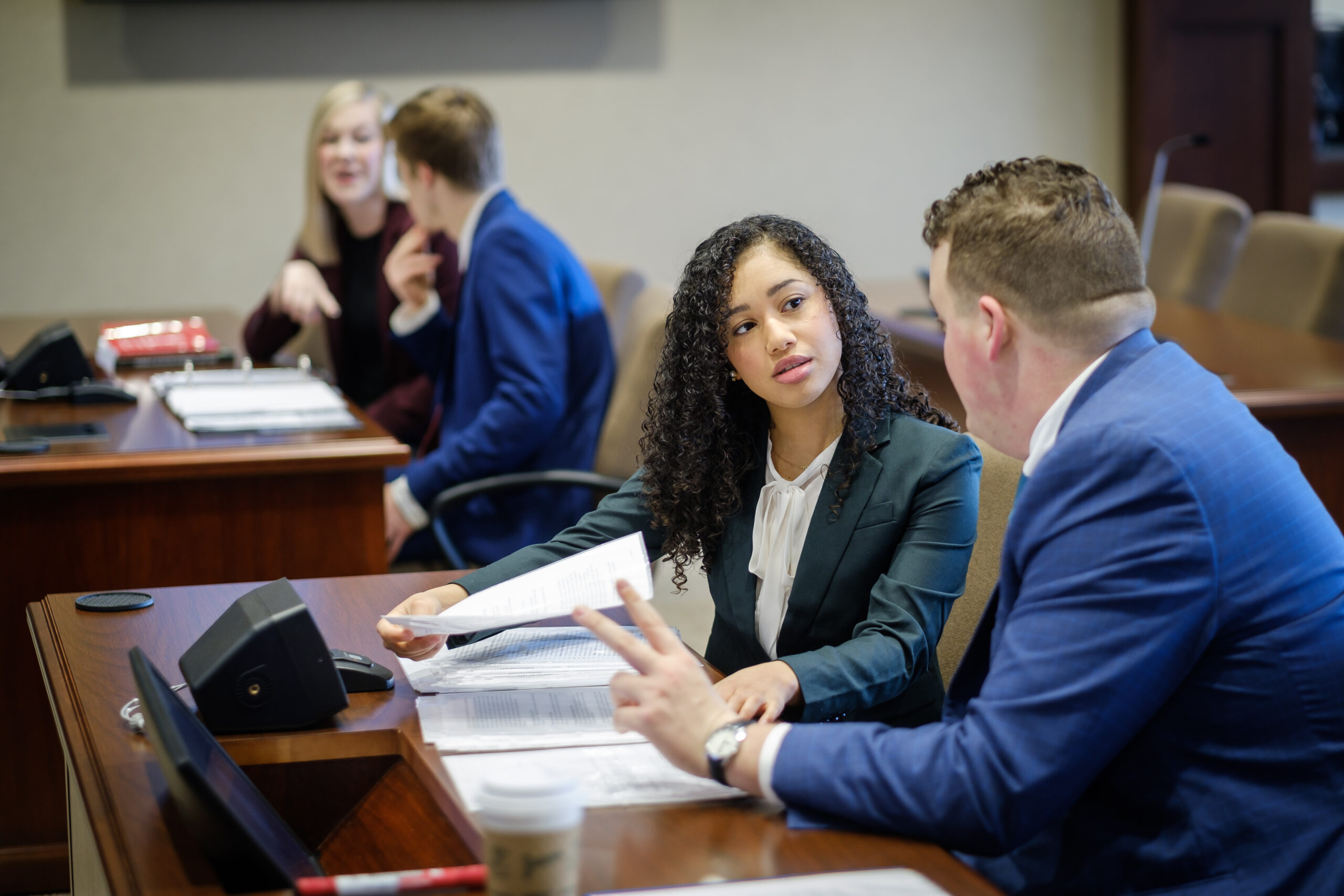 Two Wake Forest Law JD students in formal wear having a conversation during Trial Team Practice.