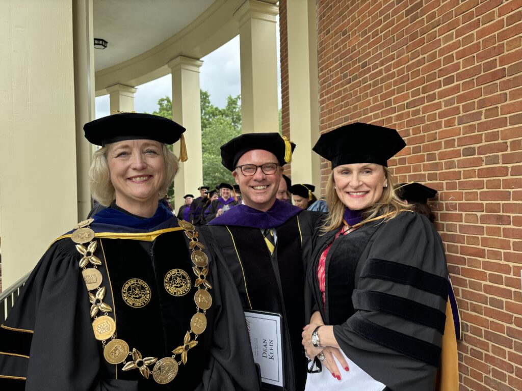 Dean Klein posing for a photo with two other Wake Forest Law graduates.