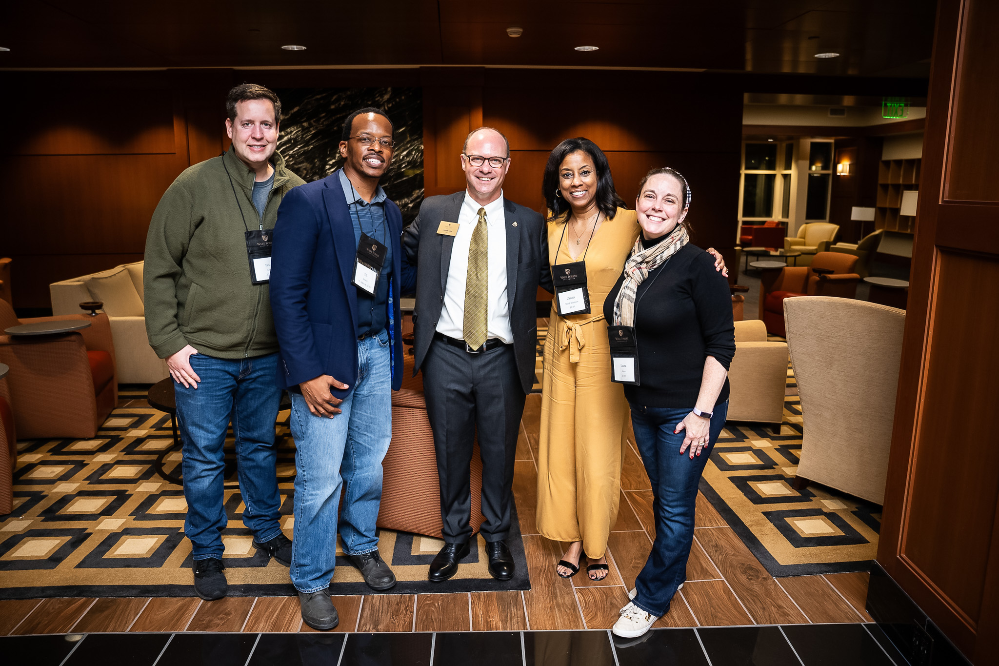 Five alumni from Wake Forest Law posing for a picture.